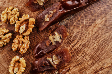 Churchkhela, composition from Georgian homemade sweets and nuts on wooden background