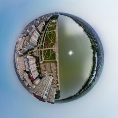 urban landscape small planet view from a bird's flight height - the full-flowing Kuban river near the western outskirts of the city on a sunny afternoon