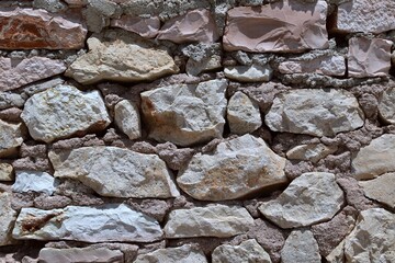Old masonry of large stones fastened with clay mortar