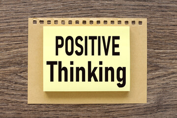 Think Positive, text on a wooden table, on a bright sticker