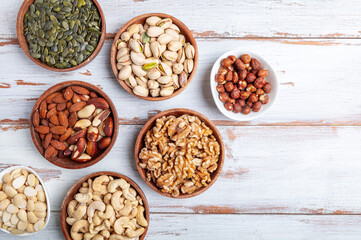 Different kind of nuts in wooden bowls