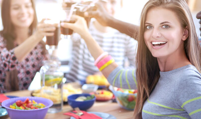 Top view of group of people having dinner together while sitting at wooden table. Food on the table. People eat fast food. Portrait of a girl