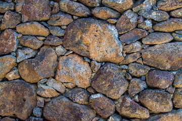 Stone wall made up of small and large rocks creating a barrier