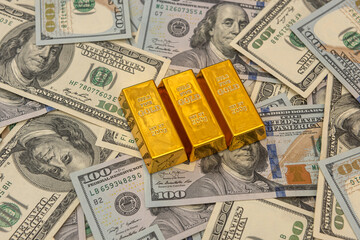 large bank gold bars bullions on dollars bills
