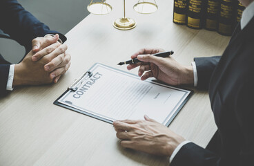 Lawyer hand holding pen and providing legal consult business dispute service at the office with...