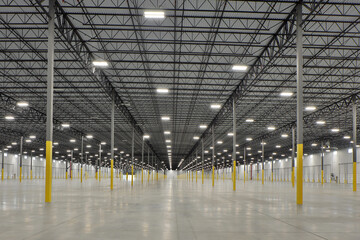Interior of large white industrial warehouse building - obrazy, fototapety, plakaty
