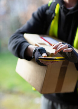 Courier with smart phone delivering package