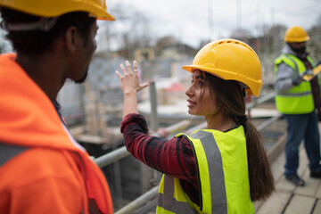 Construction workers talking at construction site