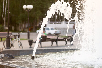 Hot summer in the city.Fountain on the city street in summer.