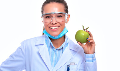 Smiling woman doctor with a green apple