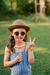 Mädchen isst Wassermelone am Stiel