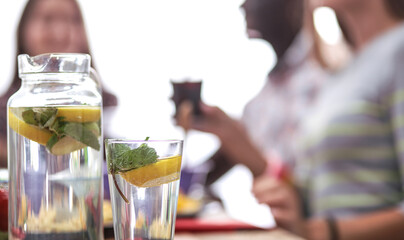 Top view of group of people having dinner together while sitting at wooden table. Food on the table. People eat fast food.