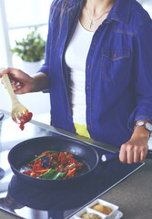 Young woman in the kitchen preparing a food