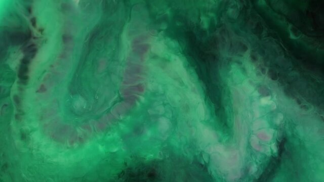 Flowing glitter waving surface. Flowing Golden abstract backdrop. Beautiful metallic green texture paint close-up. Liquid slow motion Art. Colorful Chaos Turbulence. 
