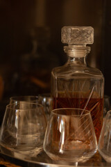 Closeup of a whiskey decanter and glasses.