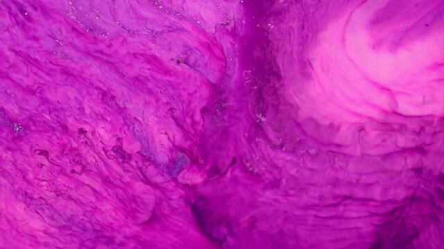 Flowing glitter waving surface. High Flow Fluid Painting. Beautiful metallic pink, purple, lilac texture paint close-up. Liquid slow motion Art. Colorful Chaos Turbulence. 