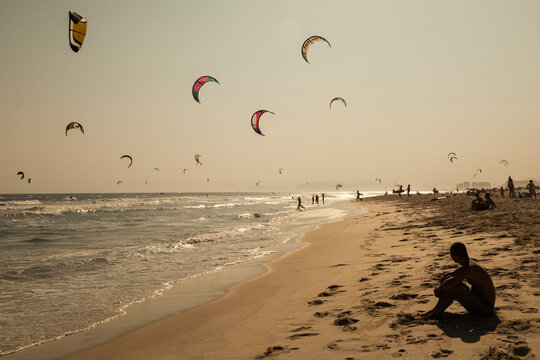 Rapaz observando kite surf na praia da Barra, Rio de Janeiro, RJ, Brasil.