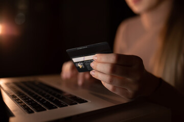 woman using laptop and credit card for online shopping in the ev