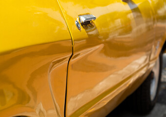 details of the door of a classic car from the 1970s 