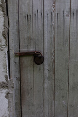 wooden brown, grey old door with ancient, old, rusty lock. close up. Background for design and presentations.