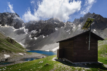 Apsoi lake, mountain lake and nearby wooden bivouac on the path to colle delle muine (pass of...