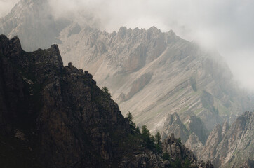 Mountain range and clouds on the path to colle delle muine (pass of muine) in maira valley, beautiful landscape in the maritime alps of Piedmont, Italy