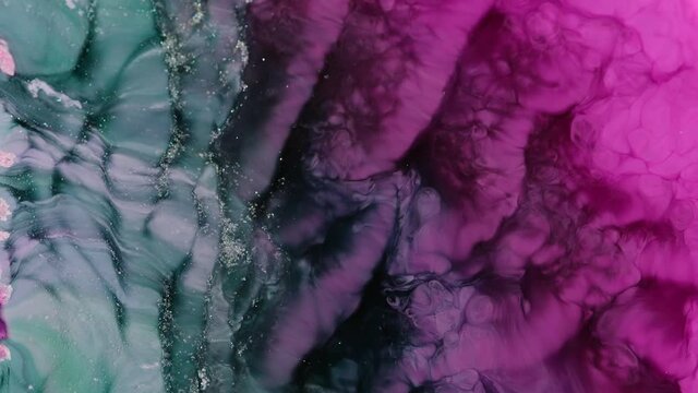 Color Flow From Top to Bottom. abstract backdrop. Beautiful metallic green, pink, blue texture paint close-up. Liquid slow motion Art. Colorful Chaos Turbulence. 