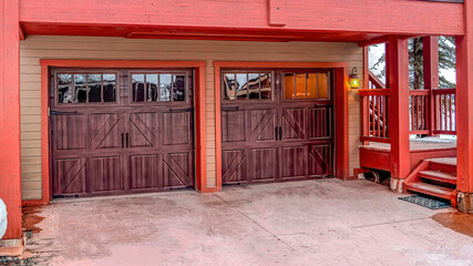 Pano House with snowy roof and balcony in winter above attached two car garage