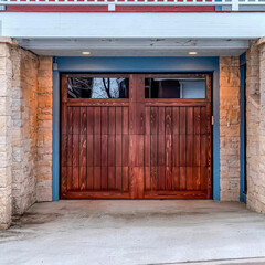 Square Brown wooden door with glass panes of an attached garage of multi storey home