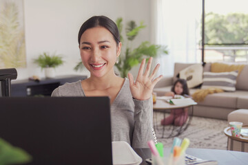 Asian woman working from home with child, remote learning, online class, Homeschooling, stay home,...