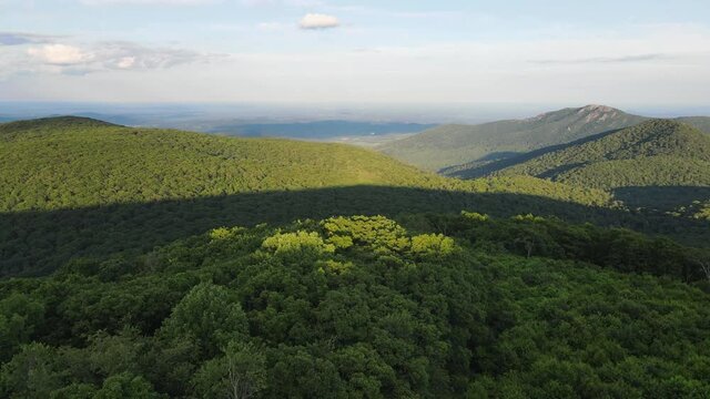 Scenic aerial overview of Shenandoah mountains and hills from above during summer sunset