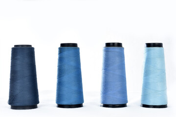 several reels of sewing thread with white background