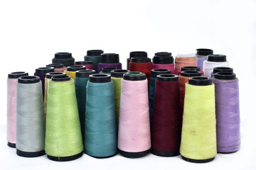 several reels of sewing thread with white background