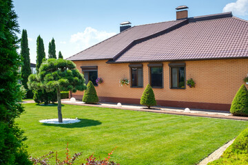 Fototapeta na wymiar European style villa and garden with nicely trimmed bushes and trees