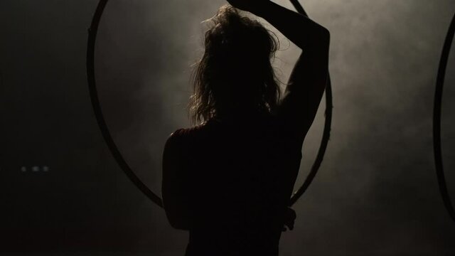 Back View Of A Woman Practicing Acrobat With Ring. Circo de los Ninos In San Pancho, Mexico. medium shot