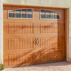 Square Brown glass paned wooden garage door of home in Huntington Beach California