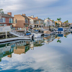 Fototapeta premium Square Huntington Beach California scenery with homes overlooking the road and canal