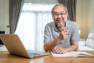 Fototapeta na wymiar Portrait of Senior elder man smile, look at camera while work at home.