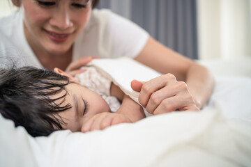 Obraz na płótnie Canvas Asian loving beautiful mother take care asleep young comfortable kid. 