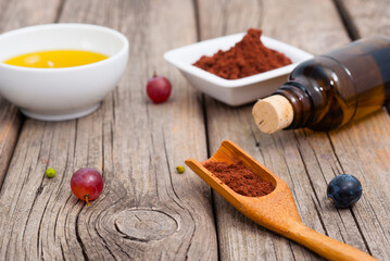 grape seed oil and grist on weathered wooden table