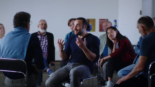 Optimistic reformed addict talking about life without alcohol during AA meeting