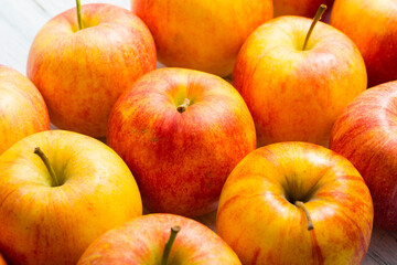 apple fruits in a row, white wooden table background