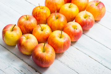 apple fruits in a row, white wooden table background