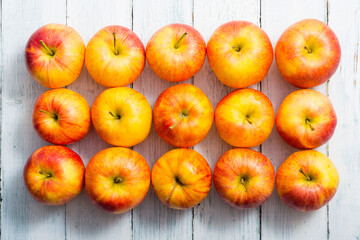 apple fruits in a row, white wooden table background