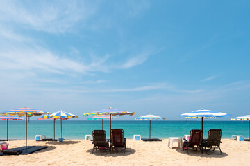 Abstract blurred background of Beautiful beach, white sand, and blue sky with tourist at Andaman Sea, Thailand. Summer vacation travel holiday background concept.
