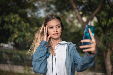 A thin and slightly anorexic woman poses for the camera to get some likes and views for her social...