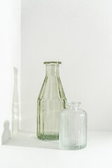 Two glass vases stand on a white background.