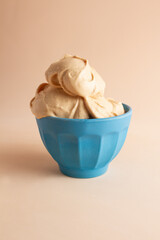 Soft ice cream cup. blue bowl, brown background