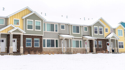 Pano Apartment houses in a snowy neighborhood with cloudy sky background in winter