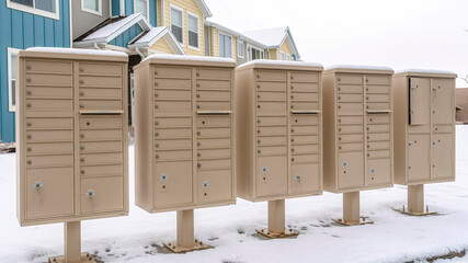 Pano Row of mailboxes on the snowy street along a wet neighborhood road in winter